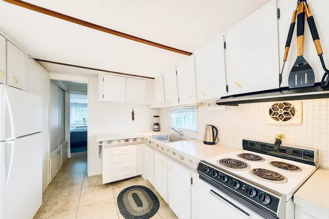 a kitchen with a stove a refrigerator and a sink