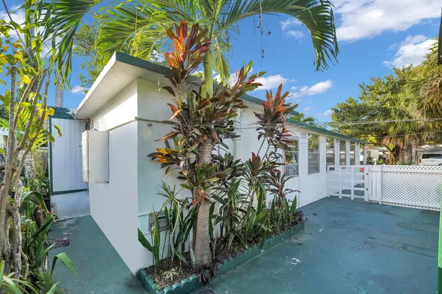 a view of a house with a flower garden