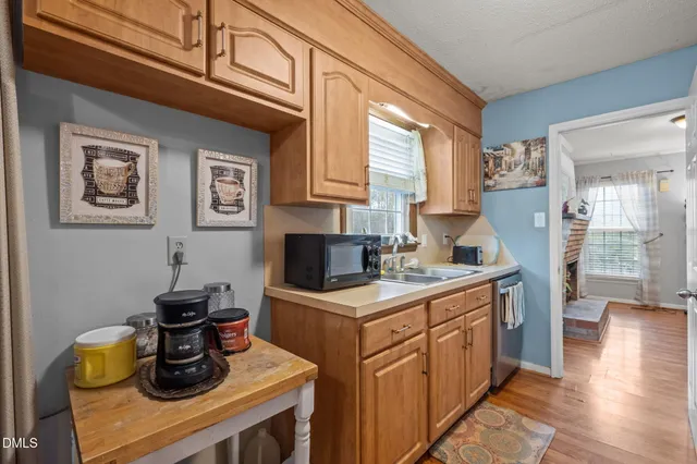 a kitchen with stainless steel appliances granite countertop a stove and a microwave