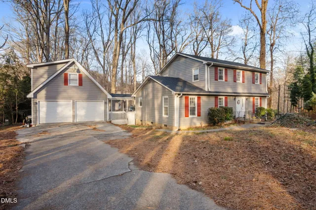 a front view of a house with porch and garden
