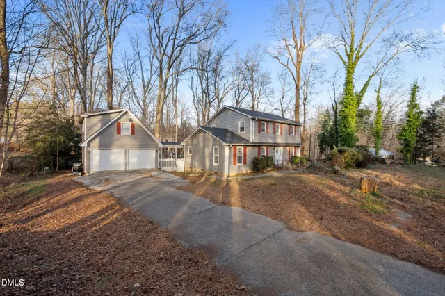 a view of a house with a yard covered in snow