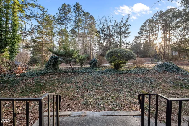 a view of balcony with wooden floor and fence