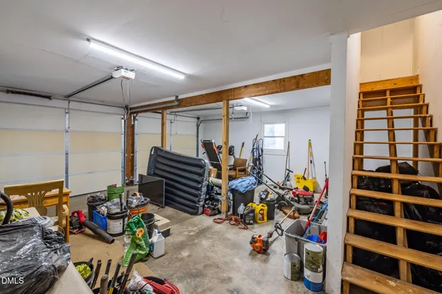 a view of a house with a deck and furniture