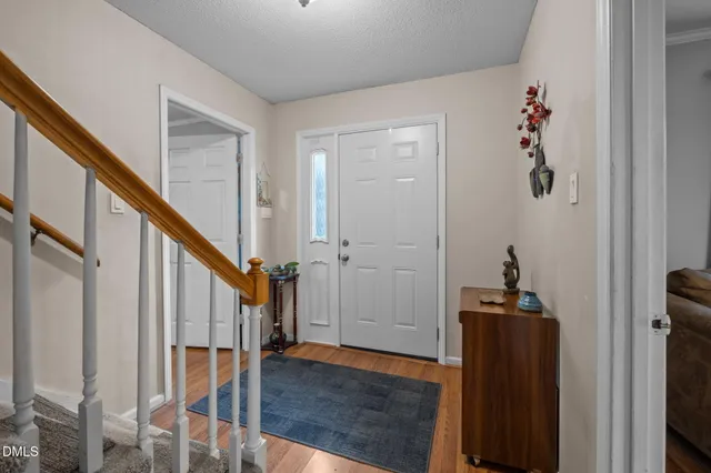 a living room with furniture a chandelier and a flat screen tv