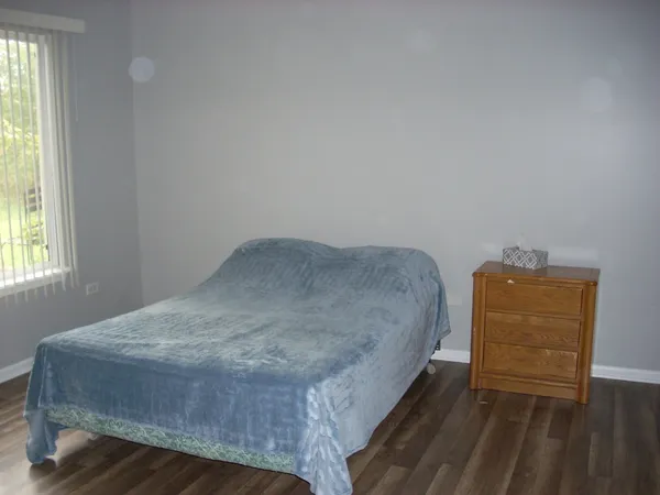 a bedroom with a bed and a cabinets