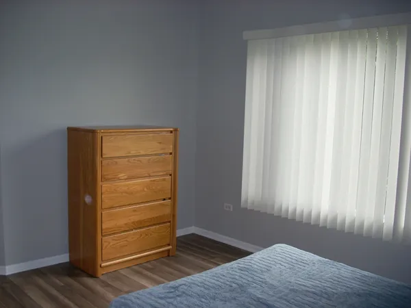 a view of walk in closet with wooden floor