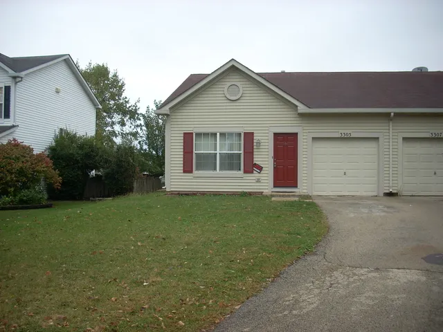 a view of a house with a yard and garage
