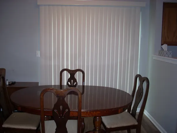 a view of a dining room with furniture and a window