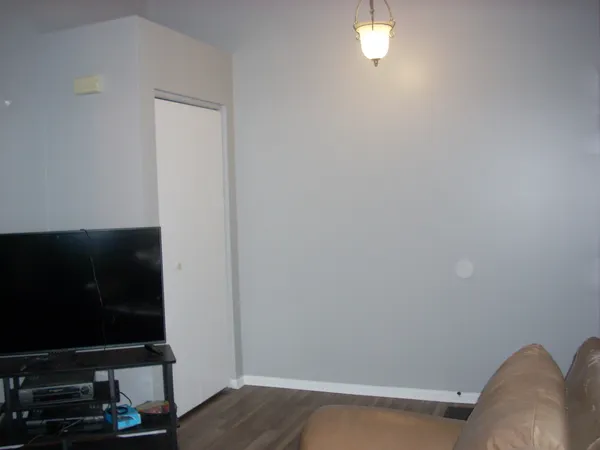 a living room with a flat screen tv and a window