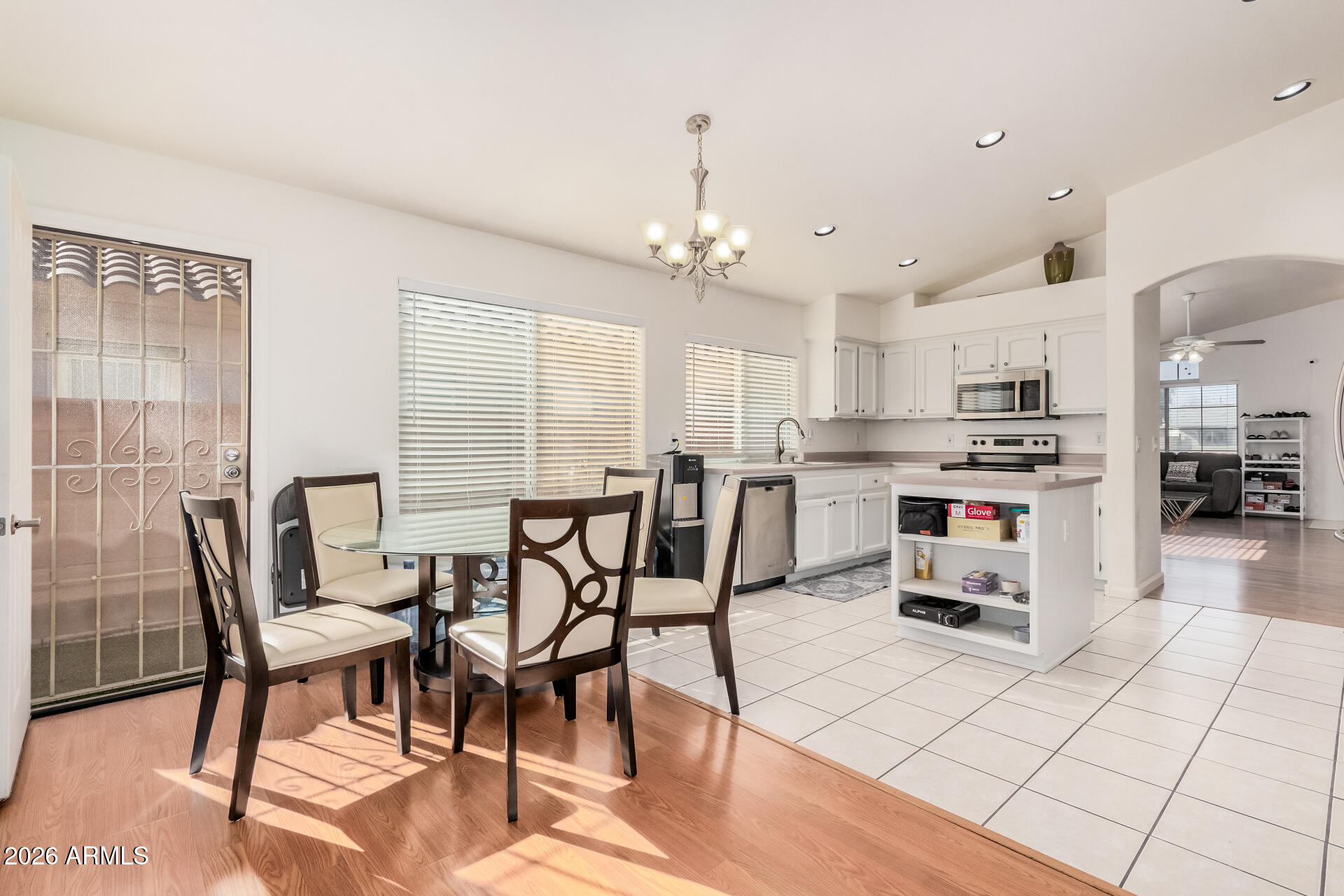17433 North 20th Street Phoenix, AZ 85022 - Photo 11 of 29 a kitchen with stainless steel appliances kitchen island granite countertop a table chairs and a view of living room