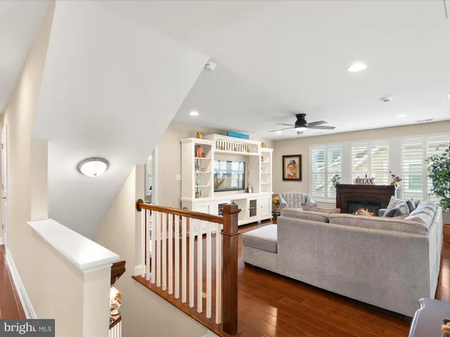 a bedroom with a bed and large windows