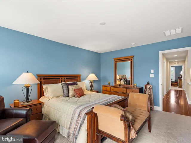 a view of a lake with a garden and outdoor seating