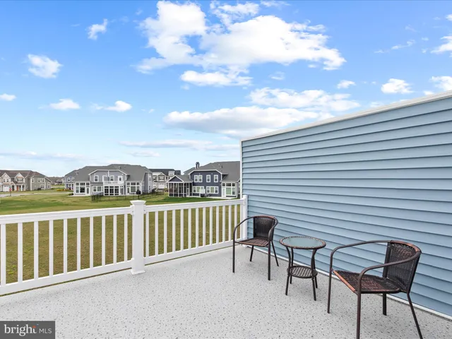 a view of a big yard with lawn chairs and a big yard