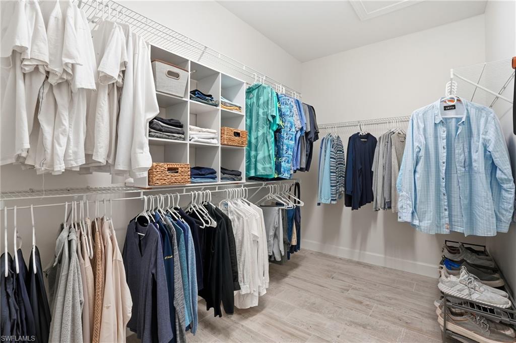 17210 Ashcomb Way Estero, FL 33928 - Photo 23 of 47 a view of walk in closet with clothes and shoes