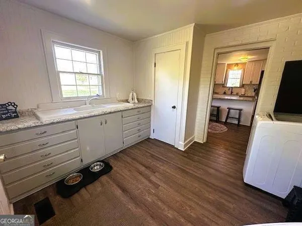 a room with wooden floors and gym equipment