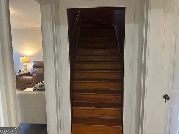 a view of closet with wooden floor