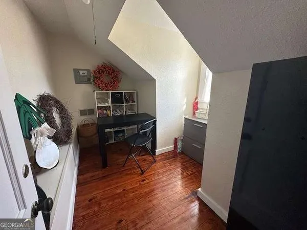 a workspace with furniture and wooden floor