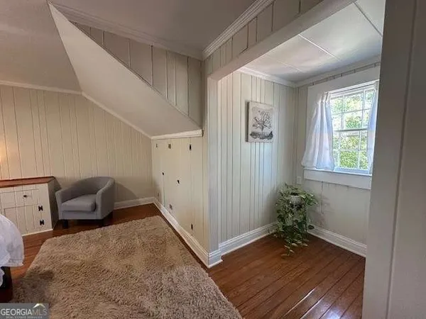 a bedroom with a bed and chair