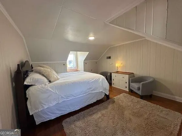 a bedroom with a bed and a chair