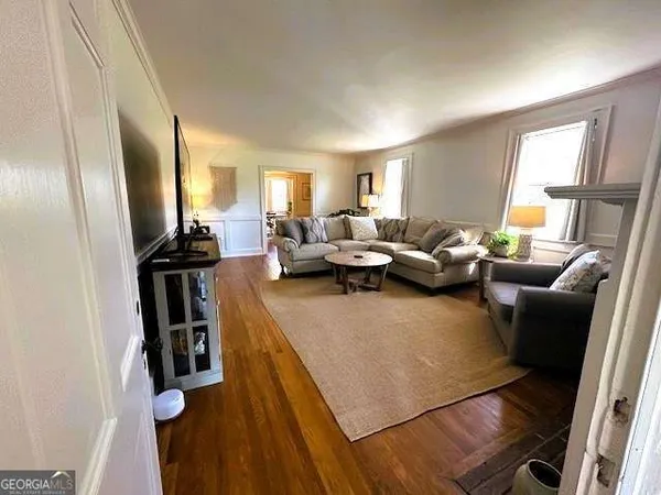 a living room with furniture window and wooden floor