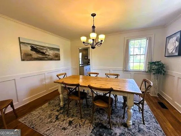 a dining room with a table and chairs