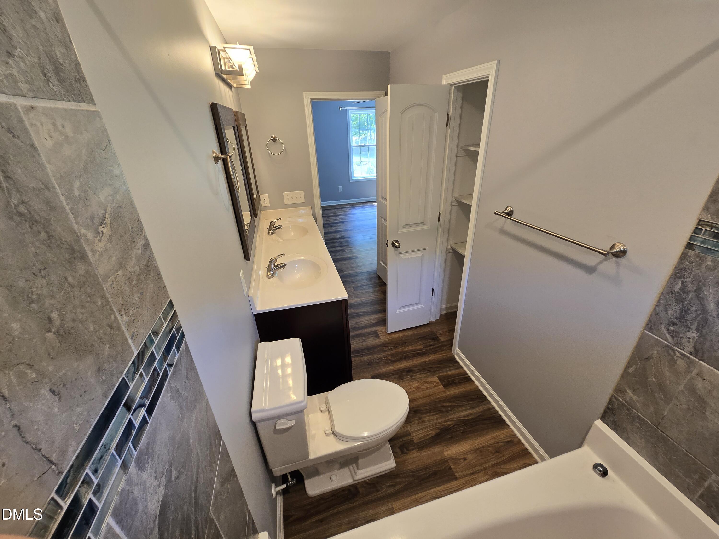 1180 Lambert Chapel Road Siler City, NC 27344 - Photo 16 of 42 a bathroom with a sink a toilet a mirror and shower