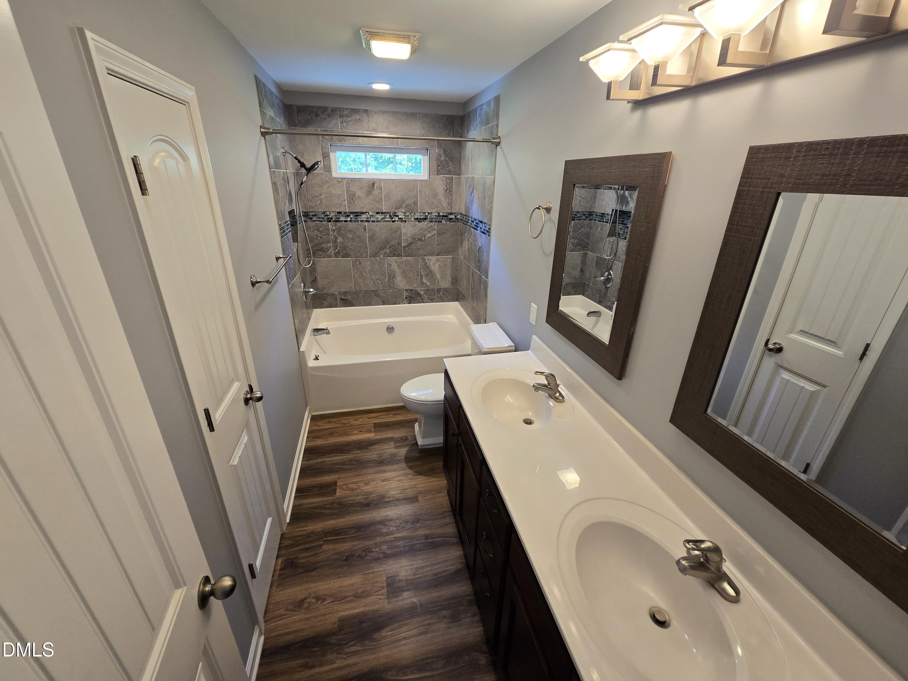 1180 Lambert Chapel Road Siler City, NC 27344 - Photo 17 of 42 a bathroom with 2 sink tub and a mirror