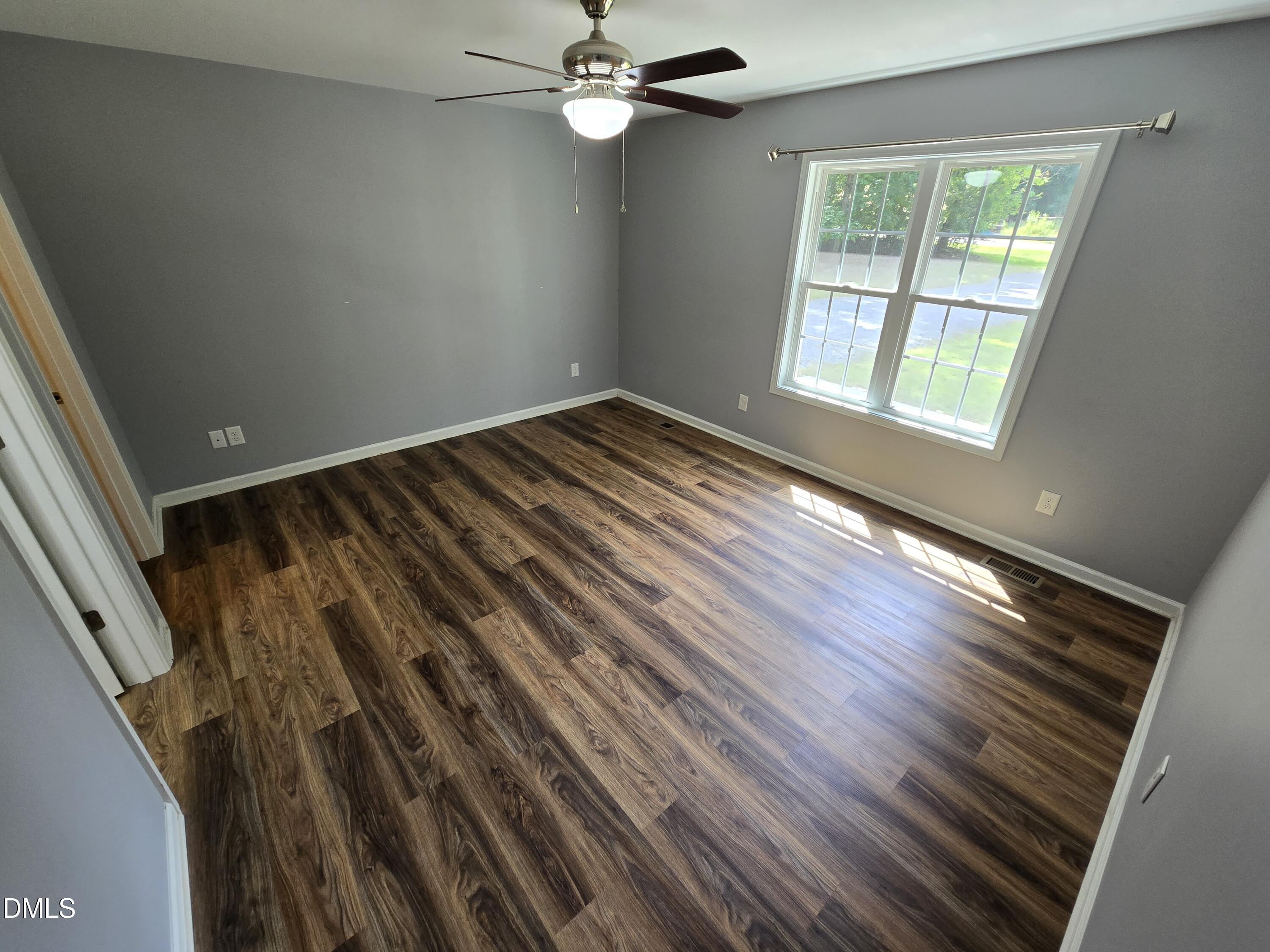 1180 Lambert Chapel Road Siler City, NC 27344 - Photo 19 of 42 a view of an empty room with wooden floor and a window