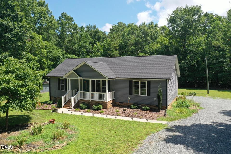 1180 Lambert Chapel Road Siler City, NC 27344 - Photo 2 of 42 a front view of a house with garden