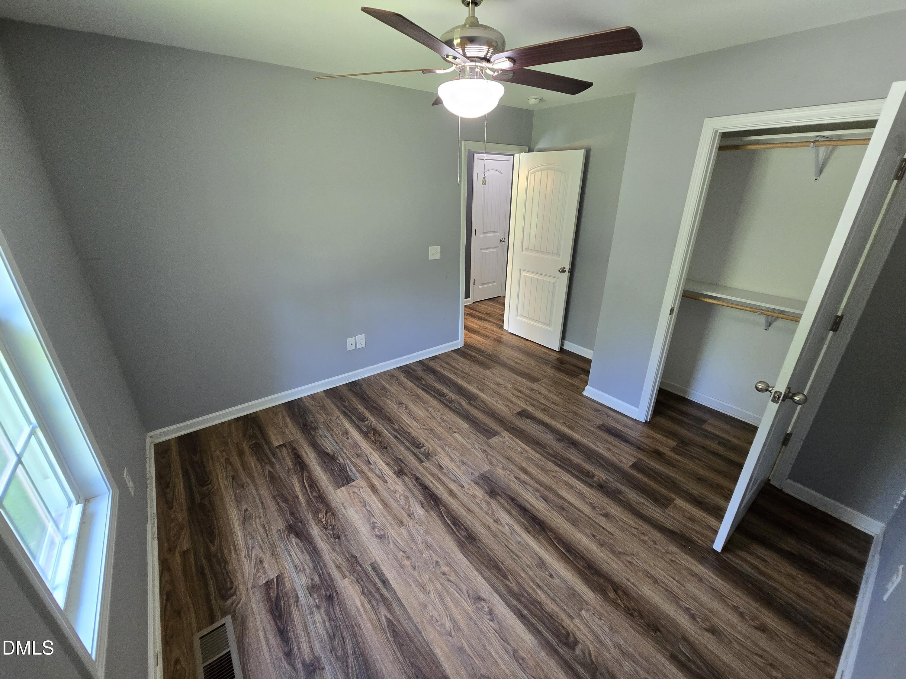 1180 Lambert Chapel Road Siler City, NC 27344 - Photo 21 of 42 a view of an empty room with wooden floor and a window