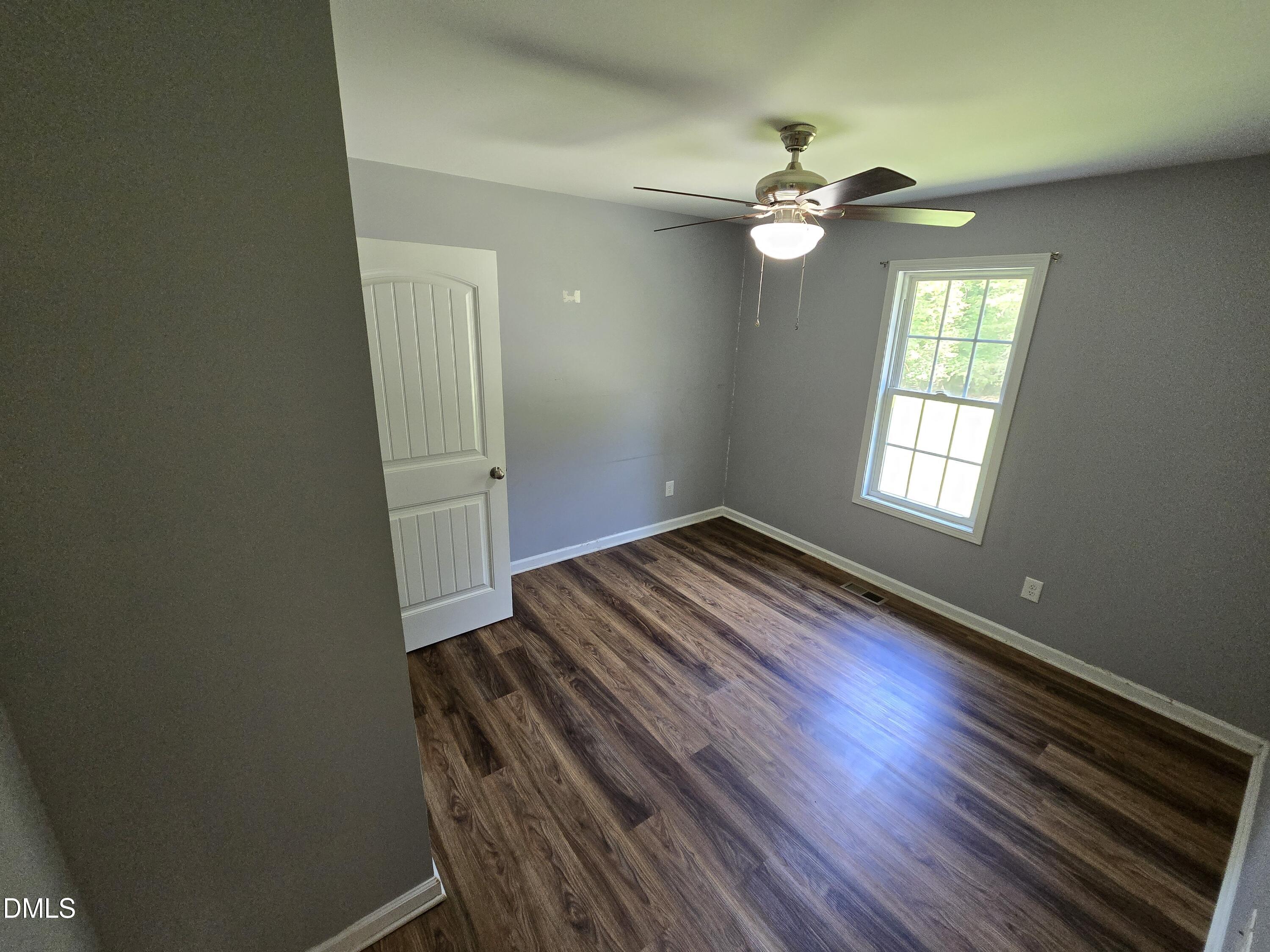 1180 Lambert Chapel Road Siler City, NC 27344 - Photo 22 of 42 a view of wooden floor and chandelier fan in a room