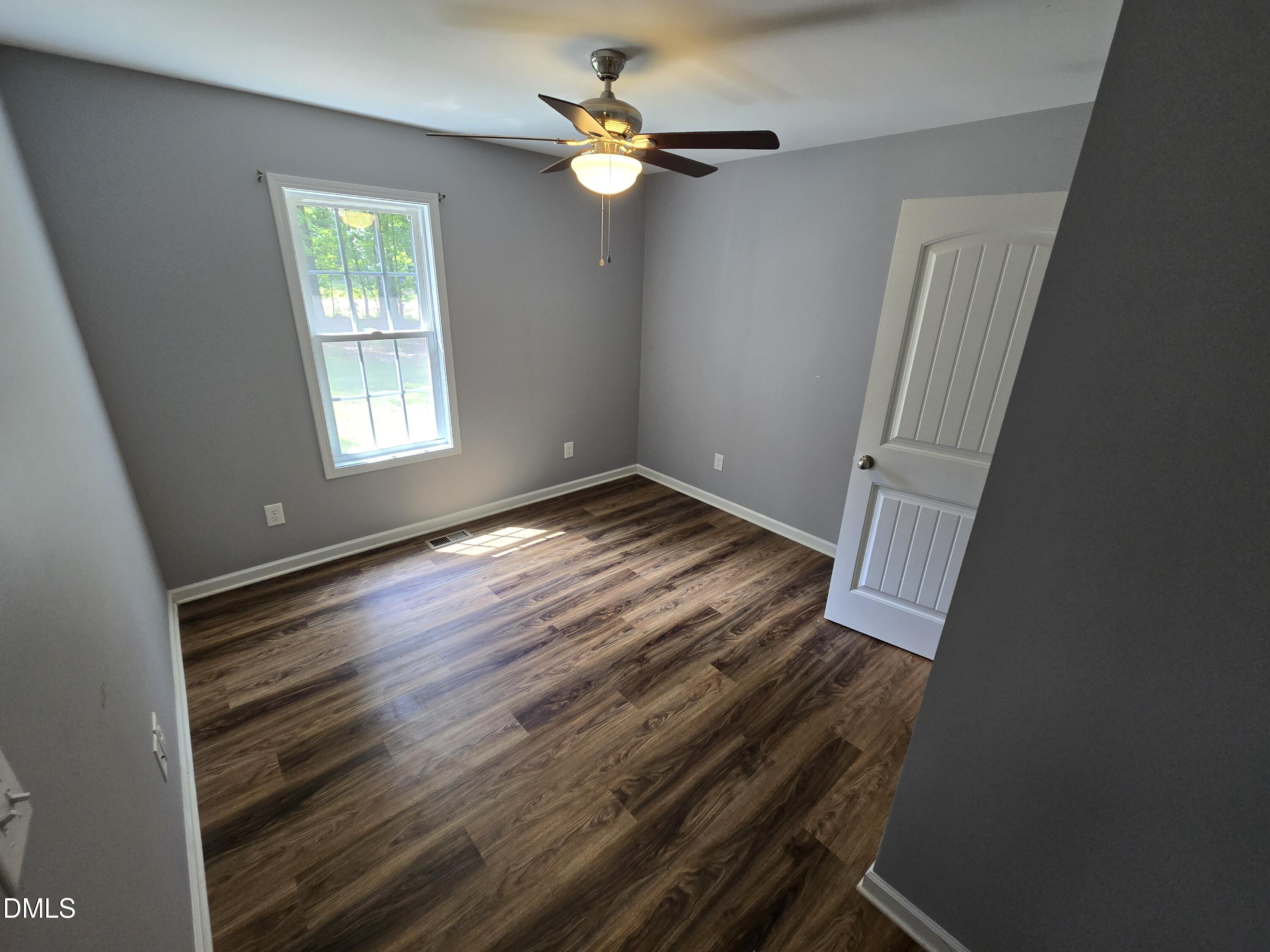 1180 Lambert Chapel Road Siler City, NC 27344 - Photo 24 of 42 wooden floor in an empty room with a window