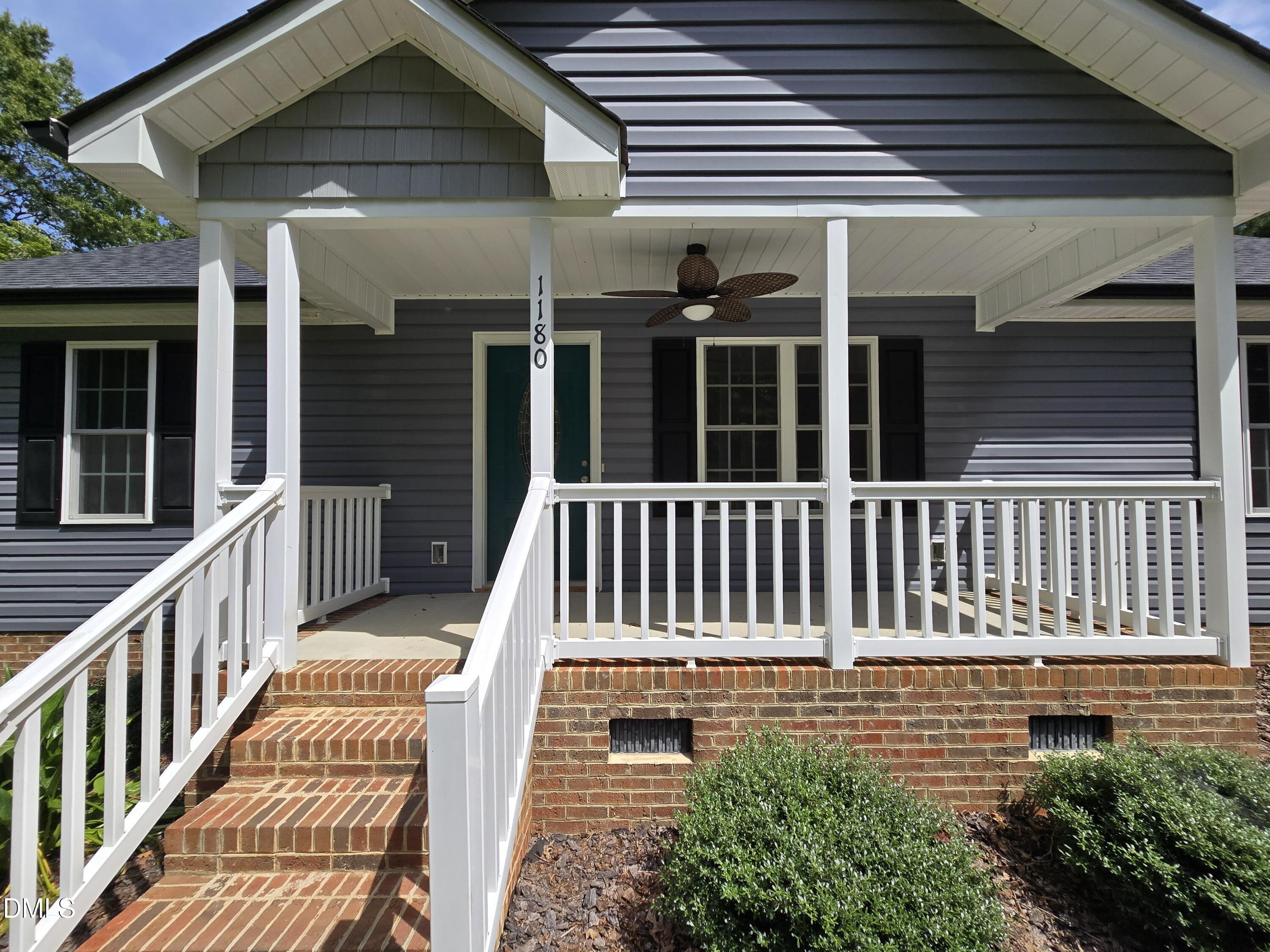 1180 Lambert Chapel Road Siler City, NC 27344 - Photo 3 of 42 a view of a brick house with wooden floor and a large window