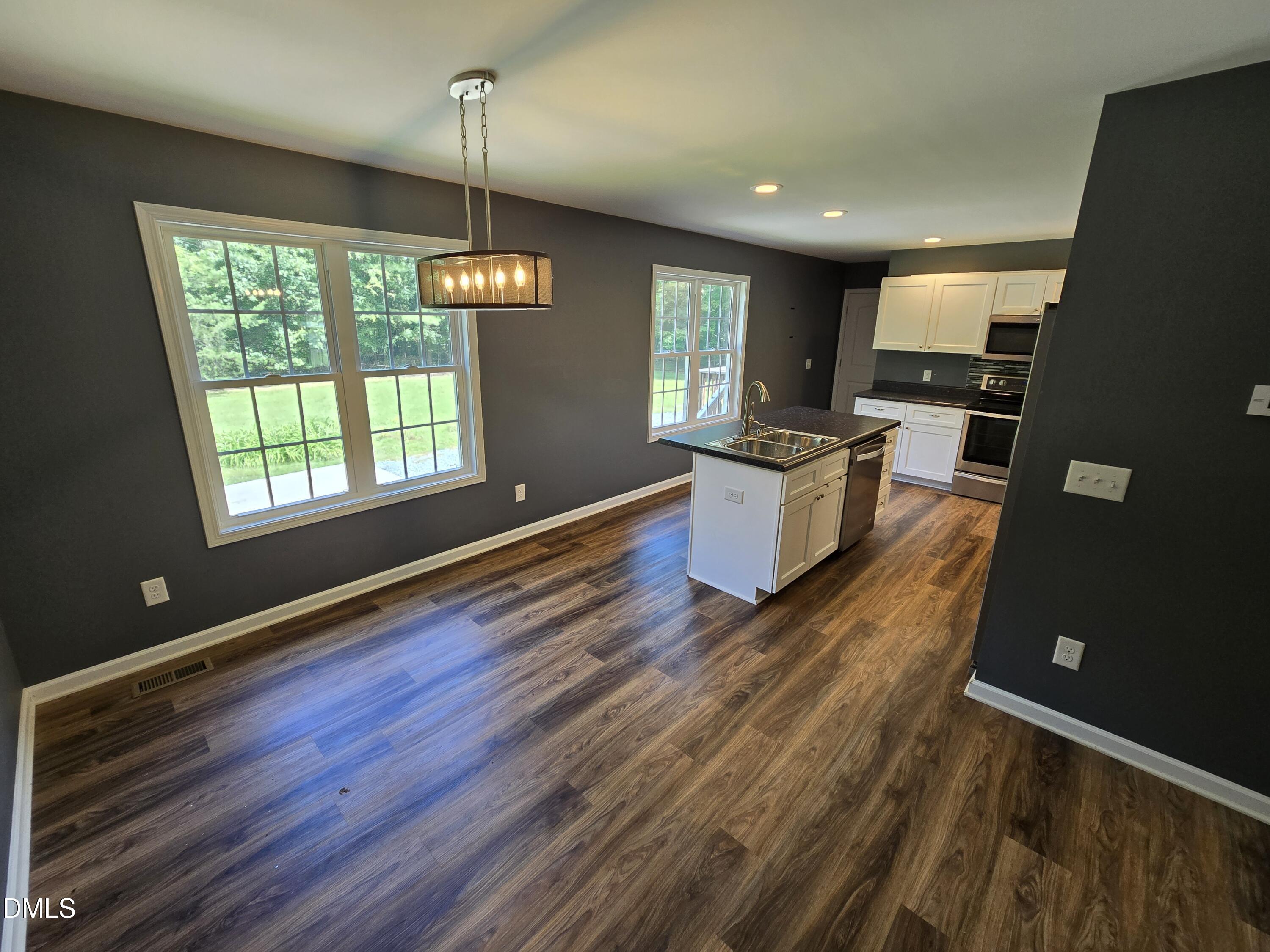 1180 Lambert Chapel Road Siler City, NC 27344 - Photo 35 of 42 a kitchen with a wooden floor and large window