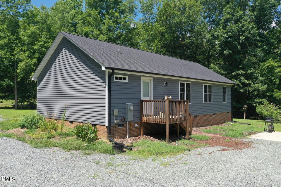 1180 Lambert Chapel Road Siler City, NC 27344 - Photo 5 of 42 a front view of a house with a yard and garage