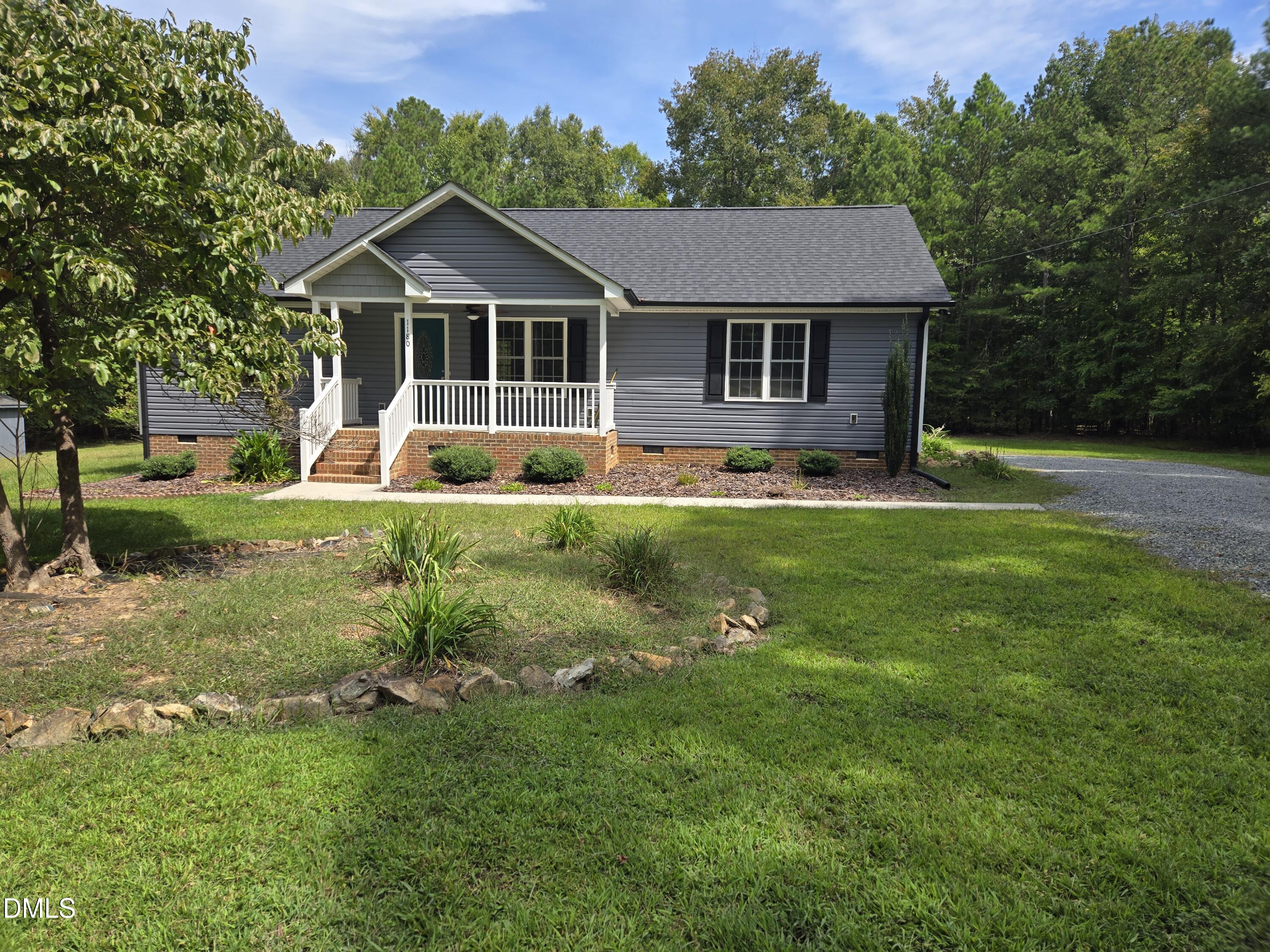 1180 Lambert Chapel Road Siler City, NC 27344 - Photo 8 of 42 a front view of a house with a yard