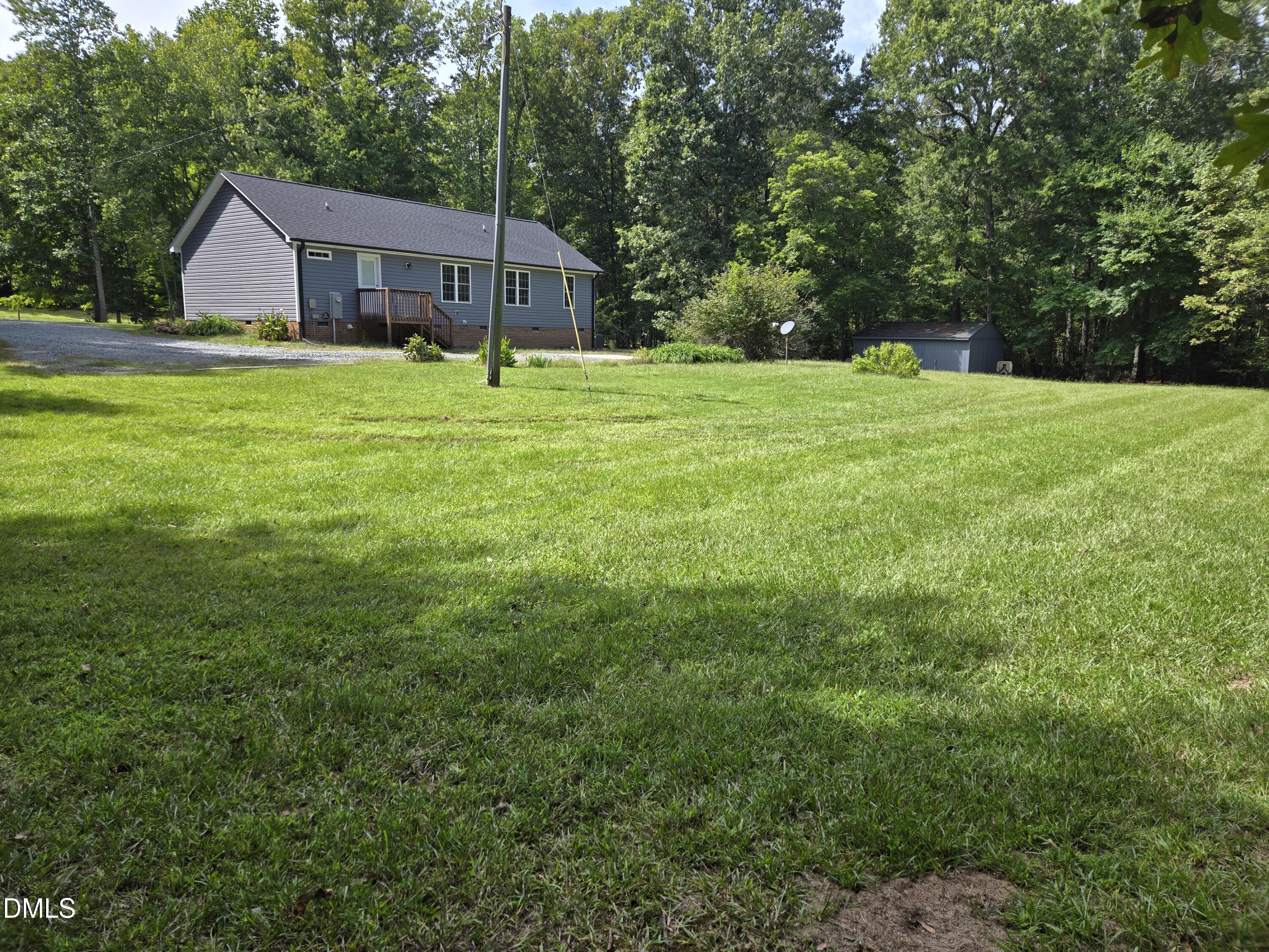 1180 Lambert Chapel Road Siler City, NC 27344 - Photo 10 of 42 a big house with a big yard and large trees