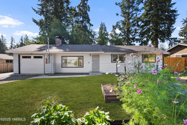a view of a house with backyard sitting area and garden