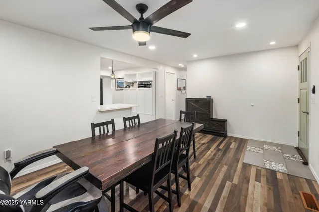 a kitchen with stainless steel appliances kitchen island granite countertop a refrigerator and a sink