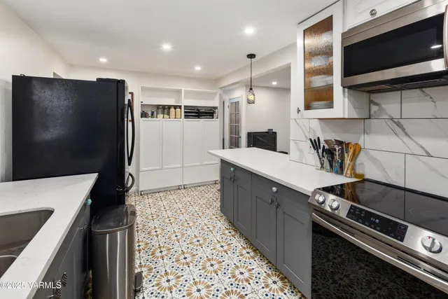 a kitchen with a sink and large window