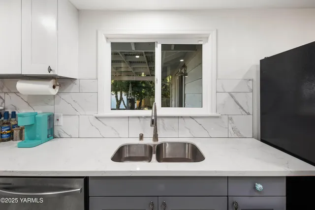 a kitchen with a sink and cabinets