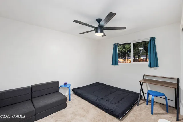 a view of a porch with furniture and a yard