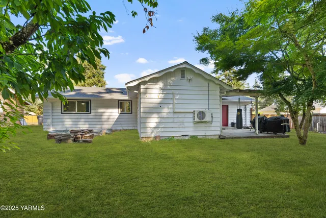a front view of house with yard and trees