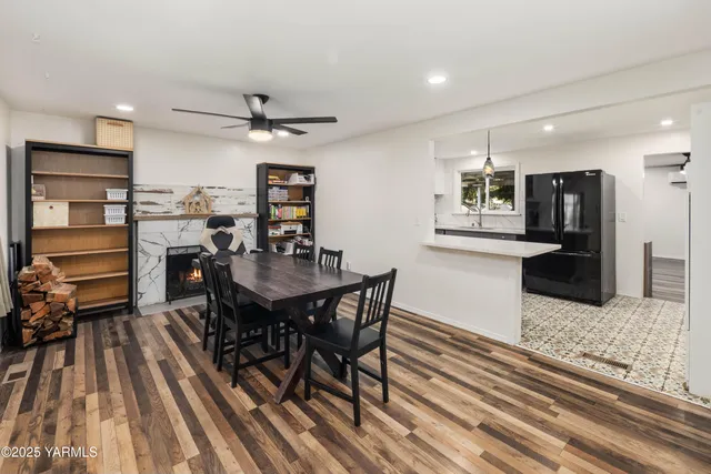 a view of a workspace with furniture and a large window