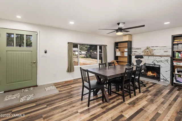 a dining room with furniture a rug and a large window