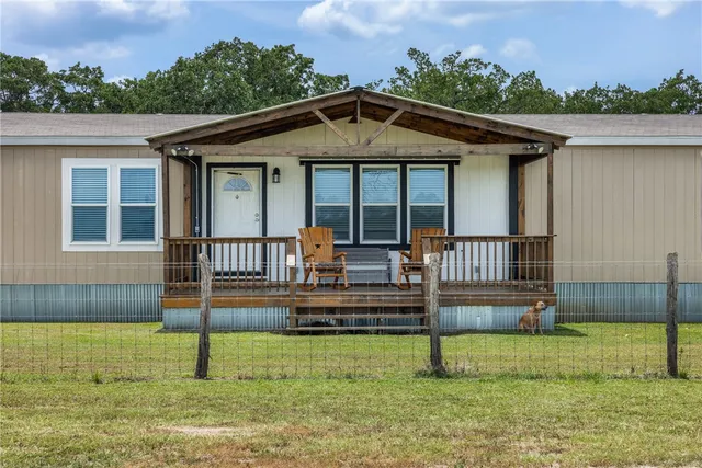 a view of a house with swimming pool and sitting area