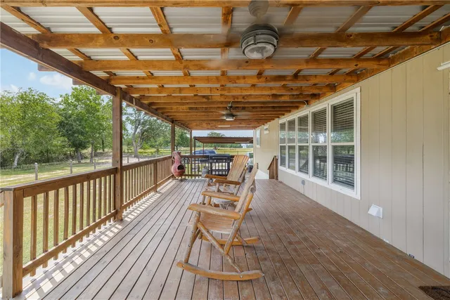 a view of a house with a bed and a lounge chair