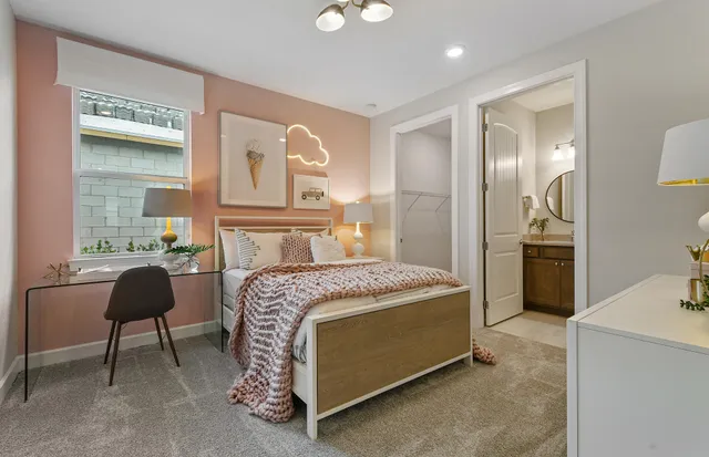 a spacious bedroom with a bed and a chandelier