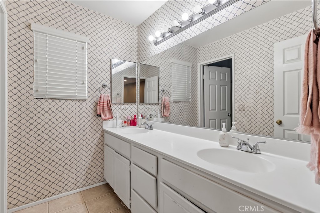152 Alabaster Loop Perris, CA 92570 - Photo 24 of 29 a bathroom with a sink and a mirror