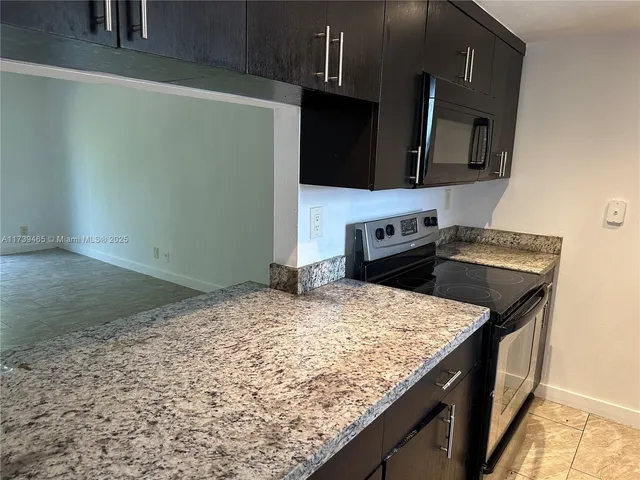 a kitchen with a sink stove and microwave